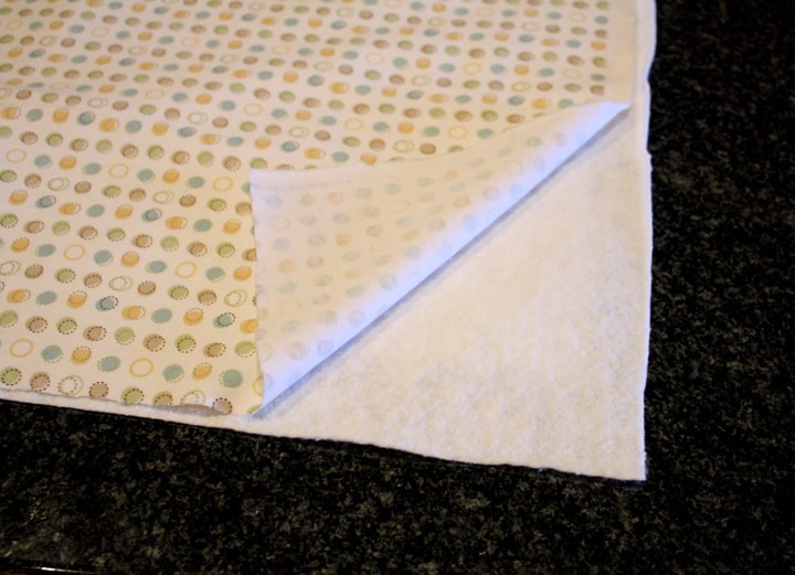 super easy baby shower quilt quilt sandwich, one corner folded back to show the batting