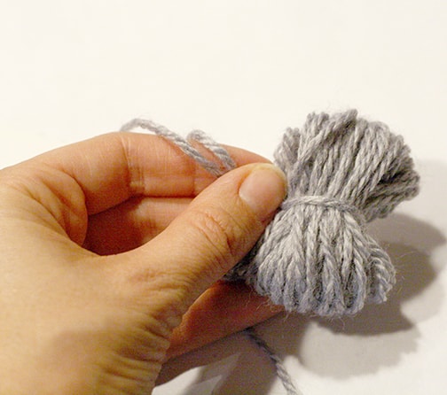 gray yarn tied in a bundle around the middle 