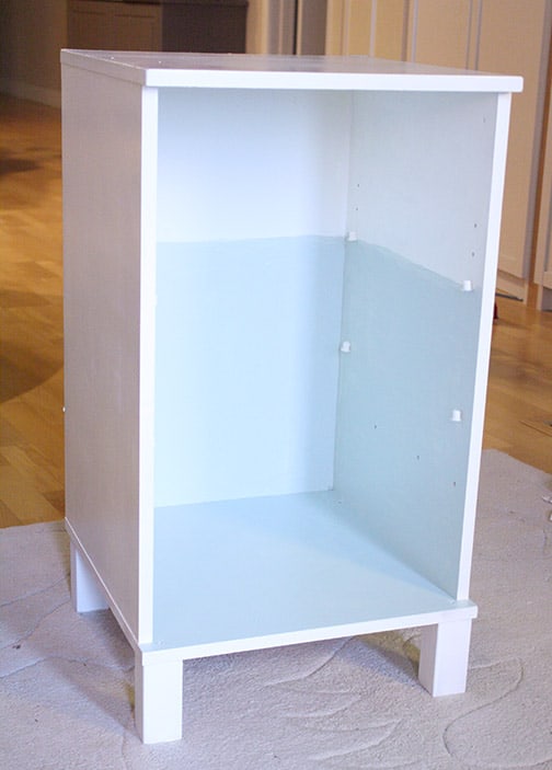 Second coat of light blue paint on the interior bottom two thirds of the nightstand, this section will be the refrigerator