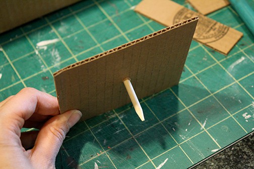 cardboard square attached to sewing machine shape as needle