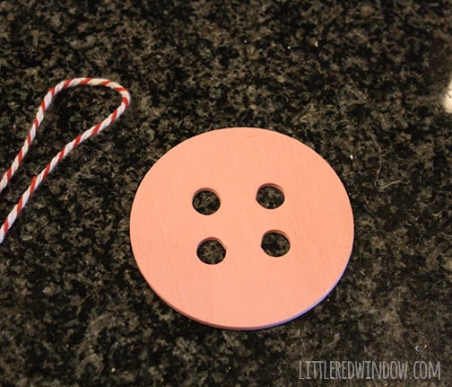 pink button and a length of red and white baker's twine