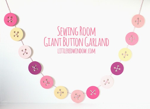 Finished giant button garland strung on twine in front of a white background