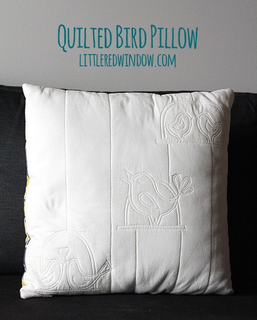 Quilted bird pillow on a couch