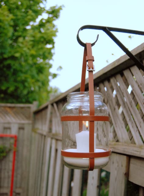 Lantern made with a glass jar and leather straps