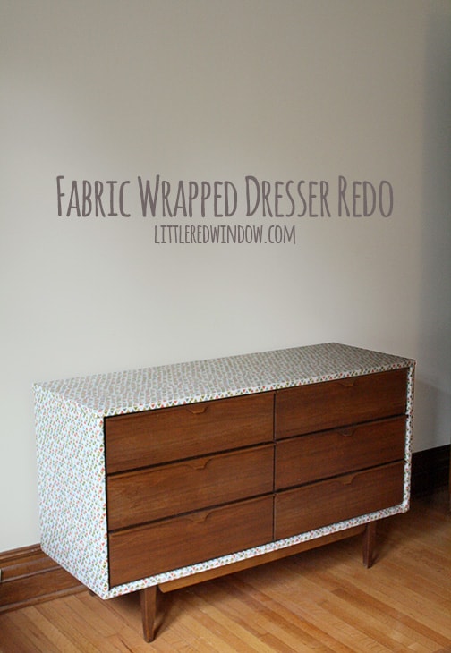 DIY Fabric Wrapped Dresser inside the house in front of a gray wall