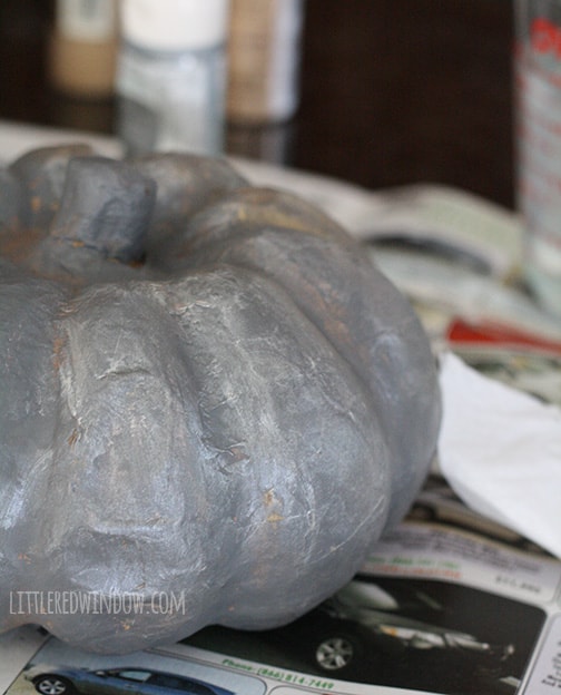 pumpkin with metallic paint applied lightly over the gray paint