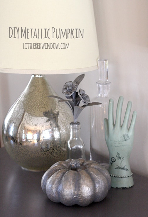DIY Spooky Metallic Pumpkin on a table with a lamp and some vases