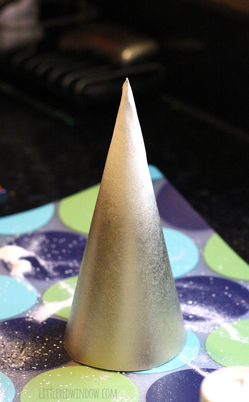 Paper cone painted gold halfway up, white on the top