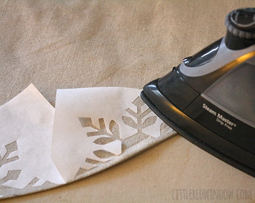 Iron ironing on snowflake stencil