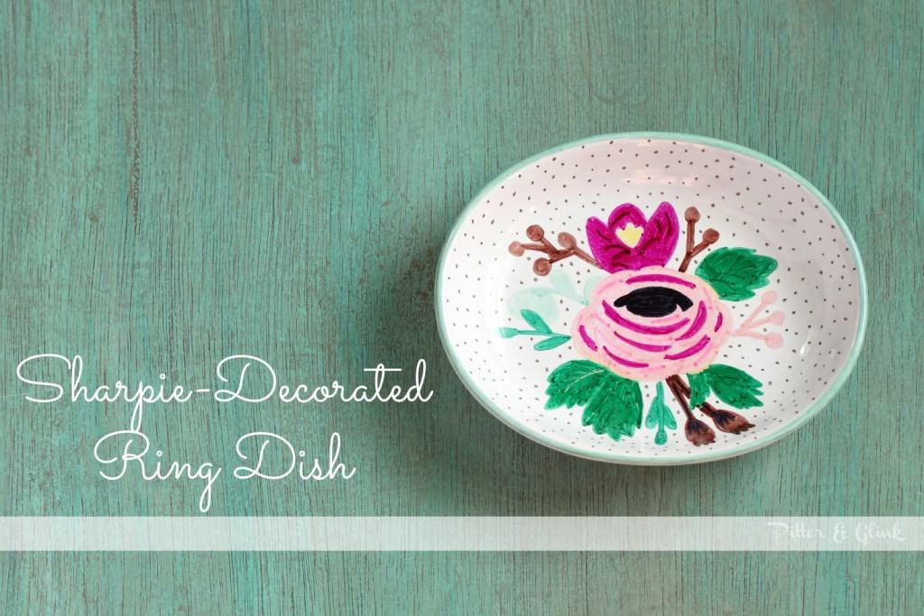 Floral painted ceramic ring dish on a green background