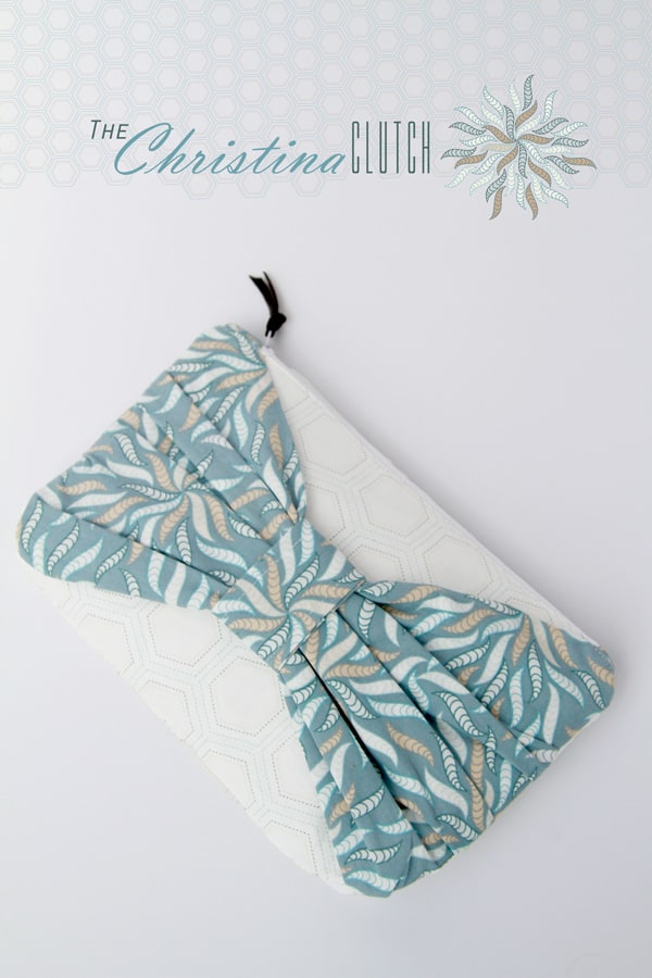 white clutch with large mint bow on the front