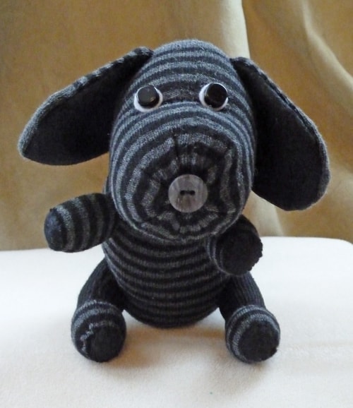 gray and black striped knit dog stuffed animal