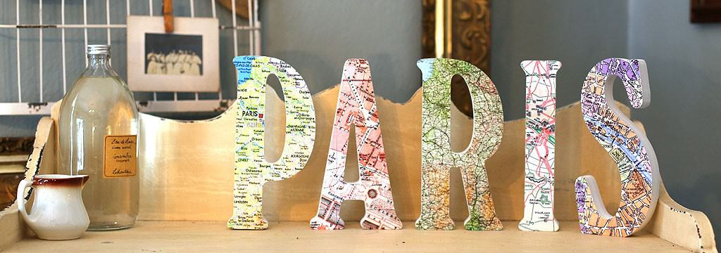 Letters of the word PARIS covered in maps