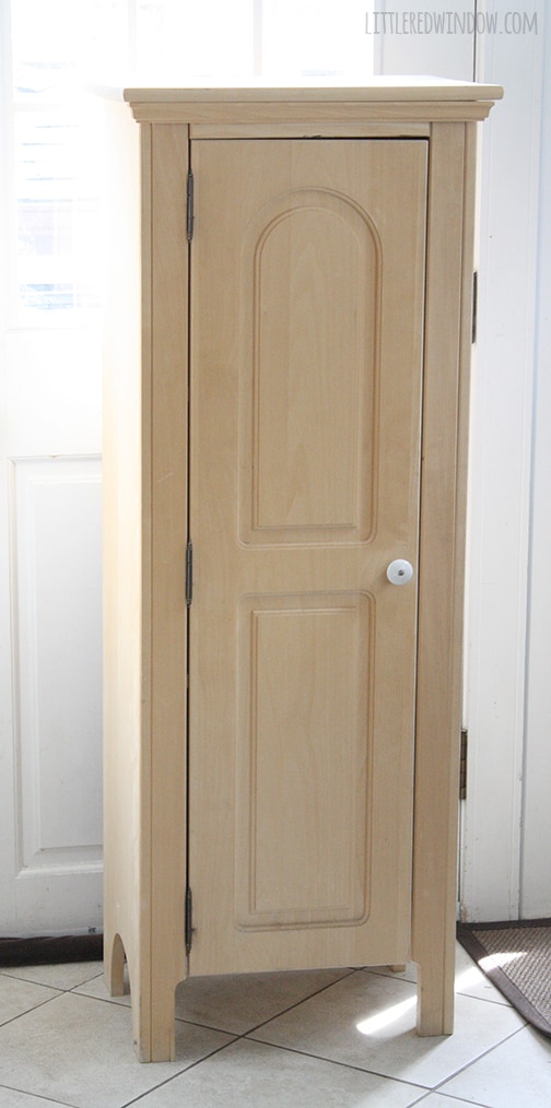 unpainted tall wood cabinet with door