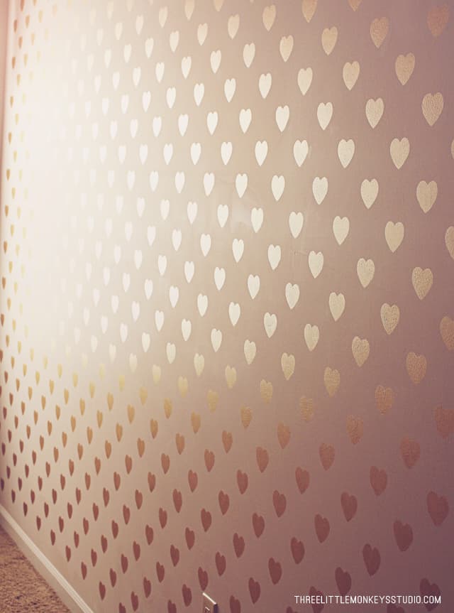 Pink wall with gold hearts all over it