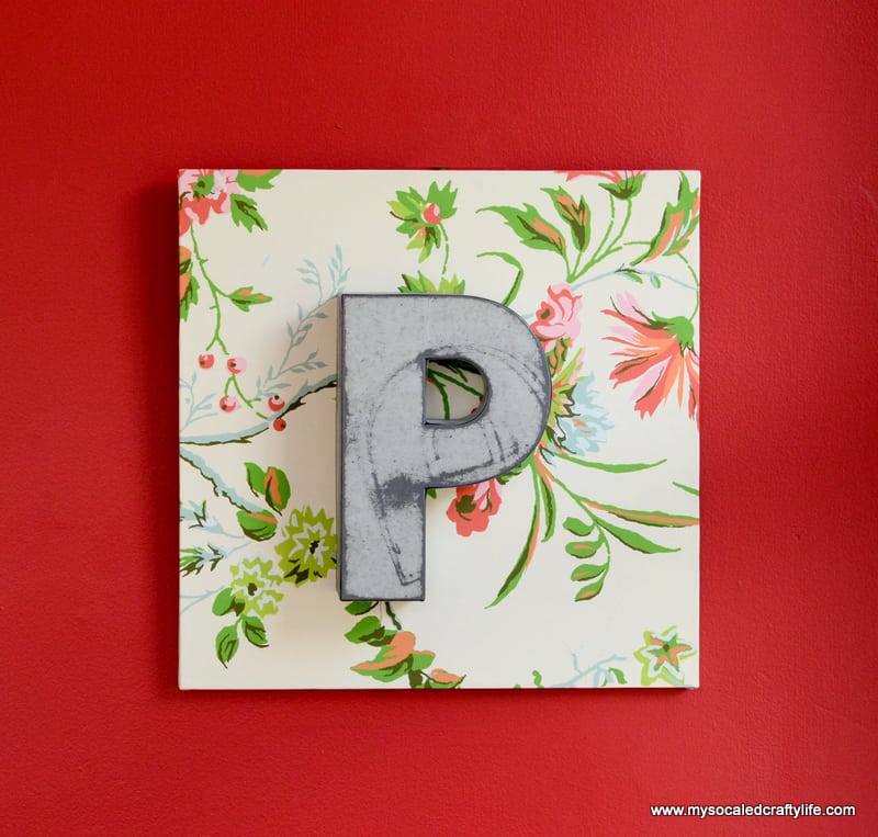 Floral square with metal letter P on top