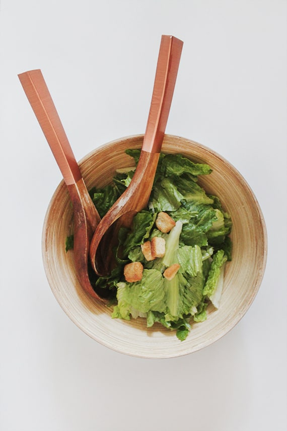 salad with salad utensils that have copper handles