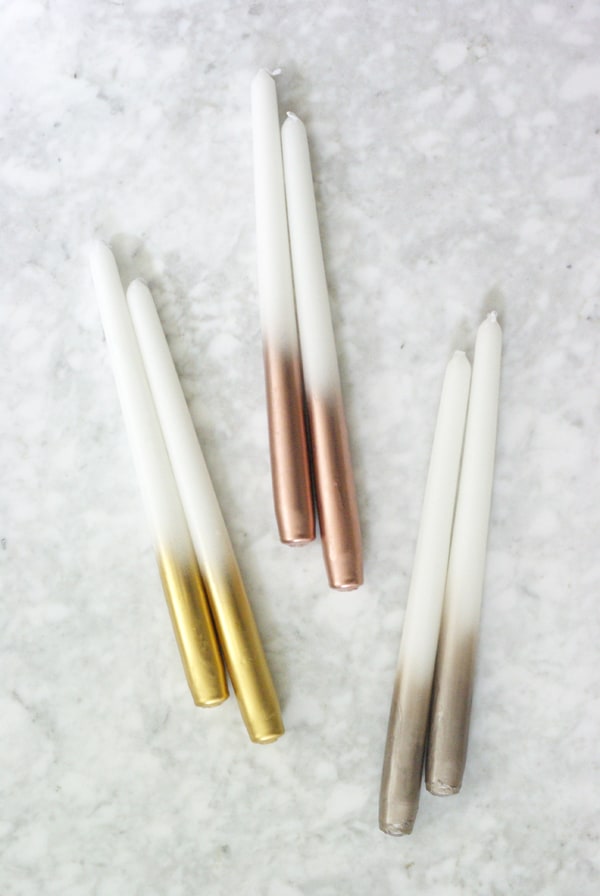 6 white taper candles dipped in metallics at the base