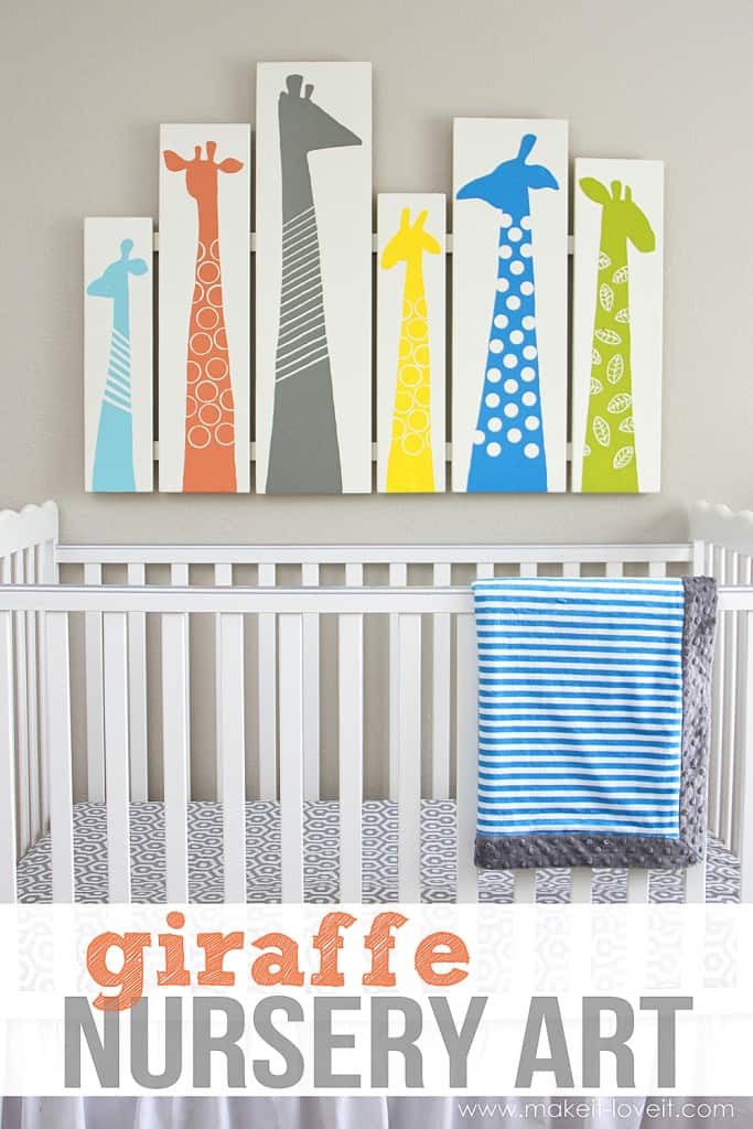 hite crib with 6 tall canvases with colored giraffe silhouettes on them
