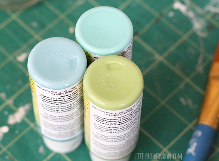 Containers of blue teal and green craft paint