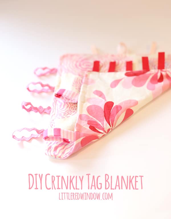 tag blanket with corner folded back to you can see different pink floral fabrics on each side