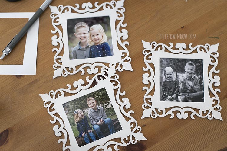 three wood frames with black and white photos of kids inside them