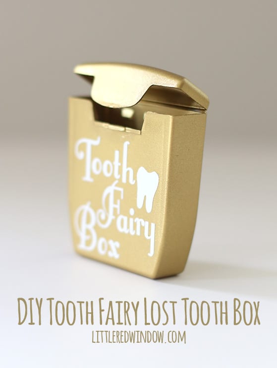 gold dental floss container wiht the words tooth fairy box and a tooth shape in white on the front with the top open