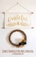 fabric wall hanging with the word grateful in gold 