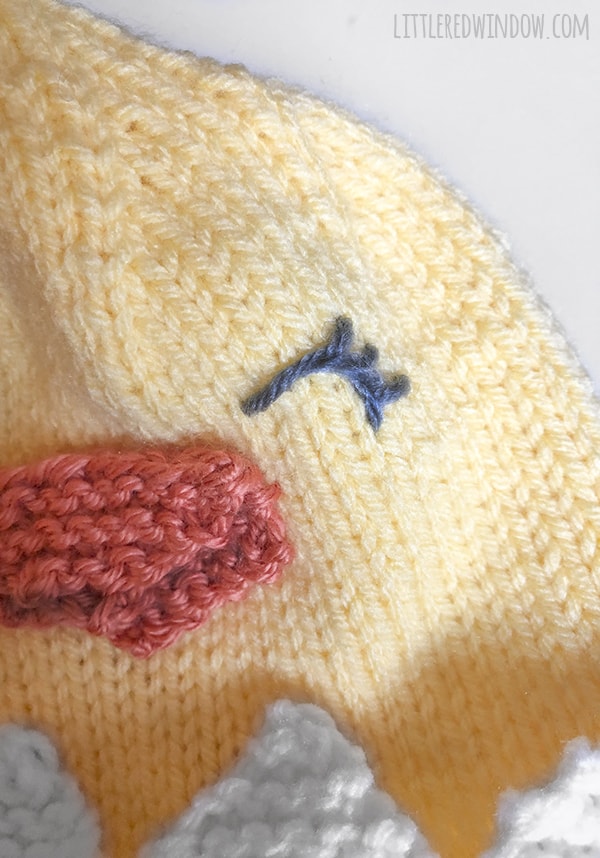 Embroider the cute face on the Little Chick Hat knitting pattern!