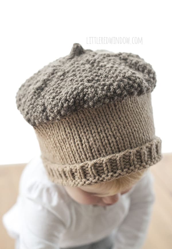 Closeup of the top of the knit acorn hat knitting pattern knit in brown and tan yarn.
