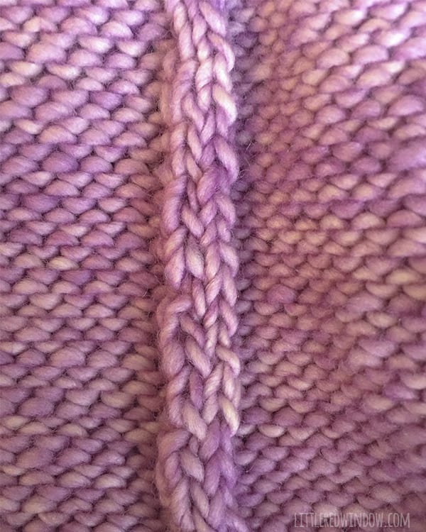 View of the invisible seam on the knit flat baby hat knitting pattern on the wrong side showing two columns of the seam edges inside 
