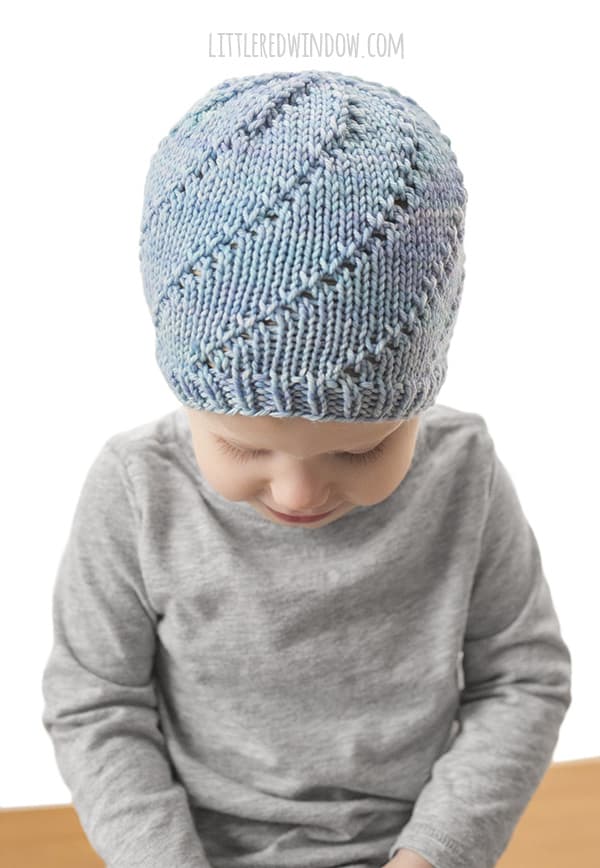 Lace Twist Hat Knitting Pattern for newborns, babies and toddlers! This pretty twisting lace pattern is easy to knit! | littleredwindow.com