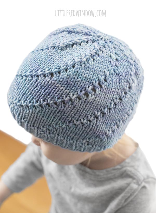 Lace Twist Hat Knitting Pattern for newborns, babies and toddlers! This pretty twisting lace pattern is easy to knit! | littleredwindow.com