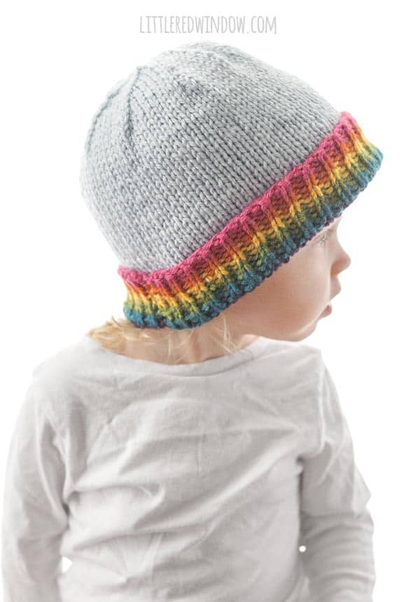 This bright and colorful Rainbow Brim Hat Knitting Pattern is a quick and easy knit for your baby or toddler! | littleredwindow.com