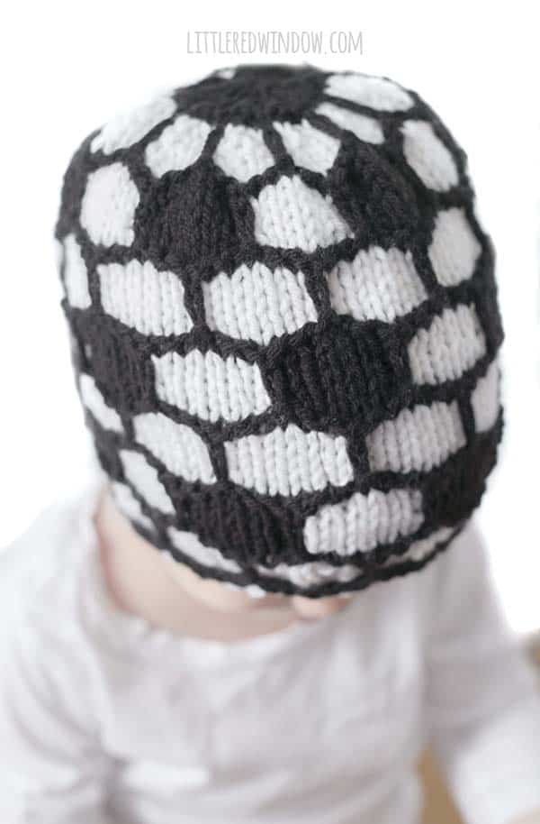 closeup of knit stitches on a black and white knit soccer ball hat
