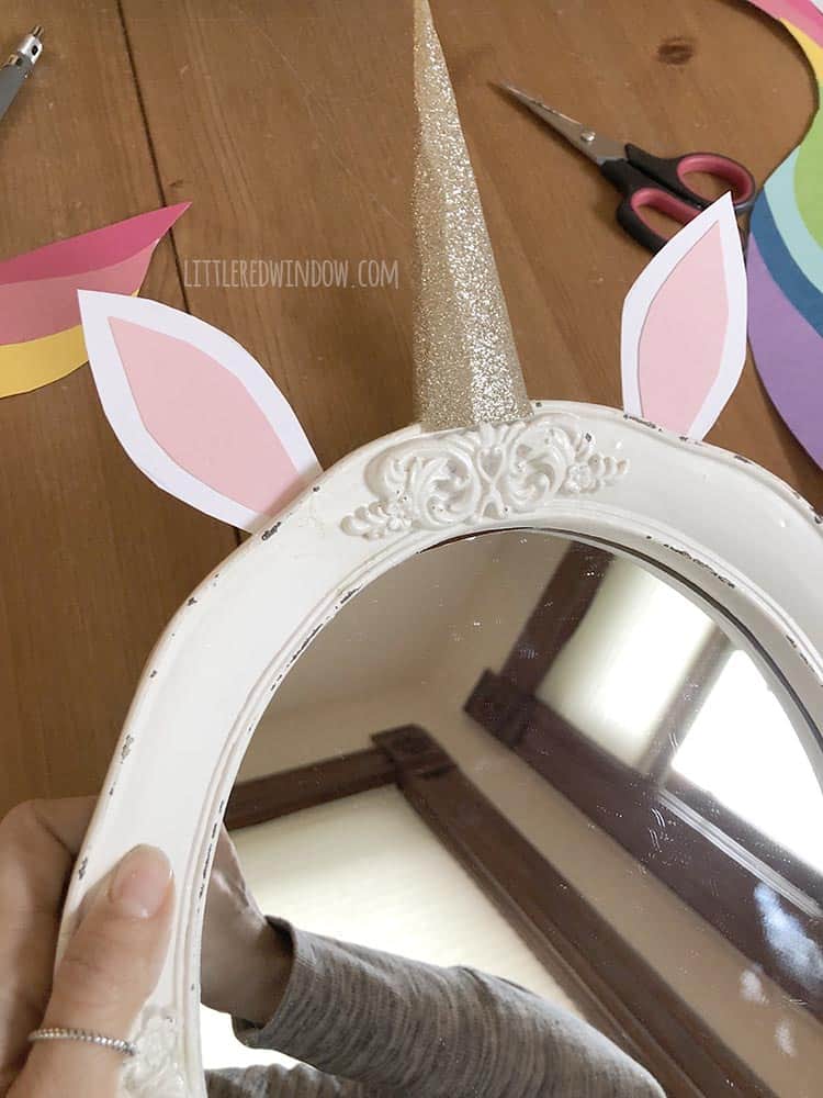 Attach the ears to your DIY unicorn mirror with hot glue