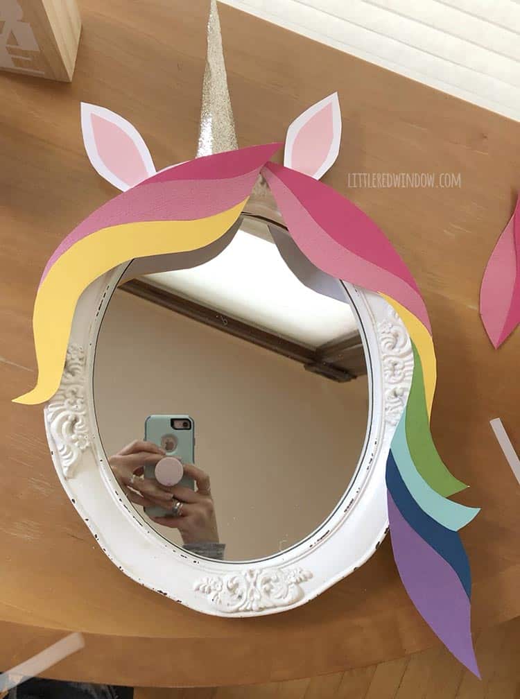 Attach the rainbow hair to your DIY unicorn mirror with hot glue
