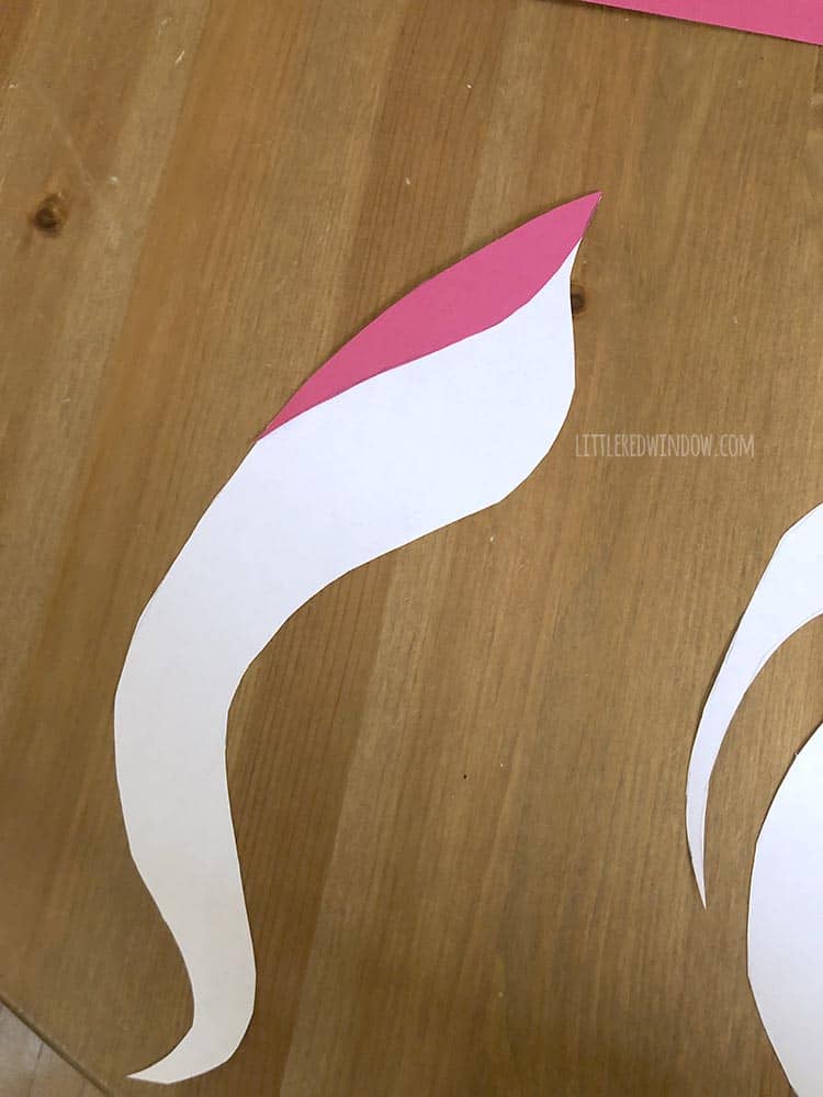 Fit the colored paper shapes onto the DIY unicorn mirror's hair template