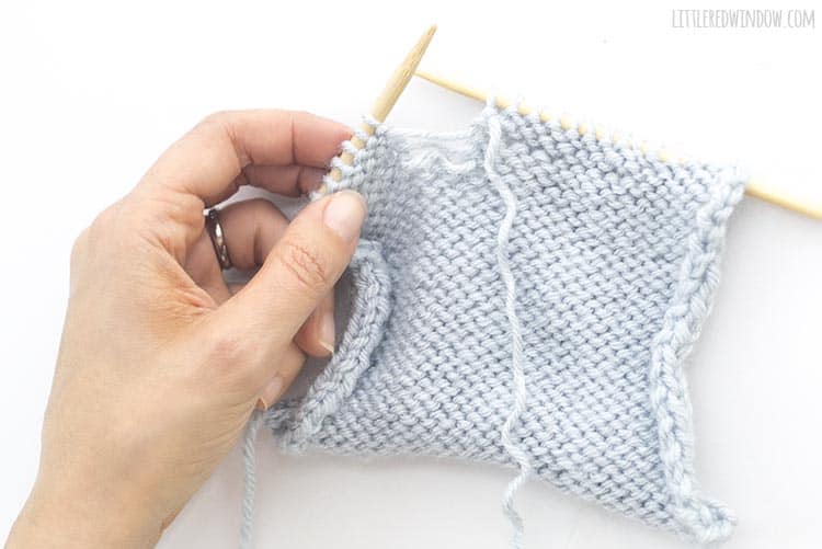 Learn how to fix a dropped purl stitch in your knitting project!