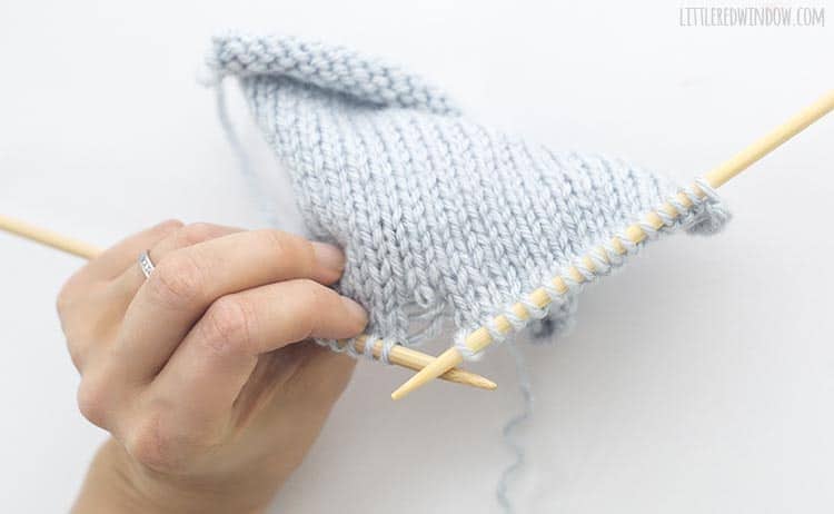 To fix a dropped purl stitch, look at the other side of your work and find the live stitch