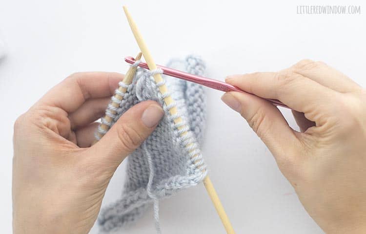 Put the dropped purl stitch back on your left knitting needle