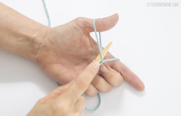 To form the stitch for a long tail cast on, use the needle to sweep and grab the yarn from your pointer finger