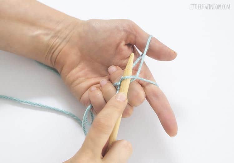To form the stitch for a long tail cast on, use the needle to sweep and grab the yarn from your pointer finger