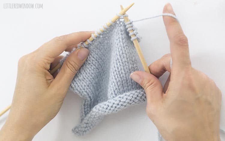 To knit a knit stitch, insert the right needle through the first stitch on the left needle from left to right
