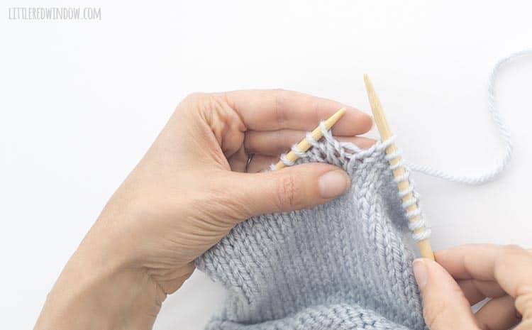 To being an m1 increase in your knitting project, find the horizontal bar of yarn between two stitches