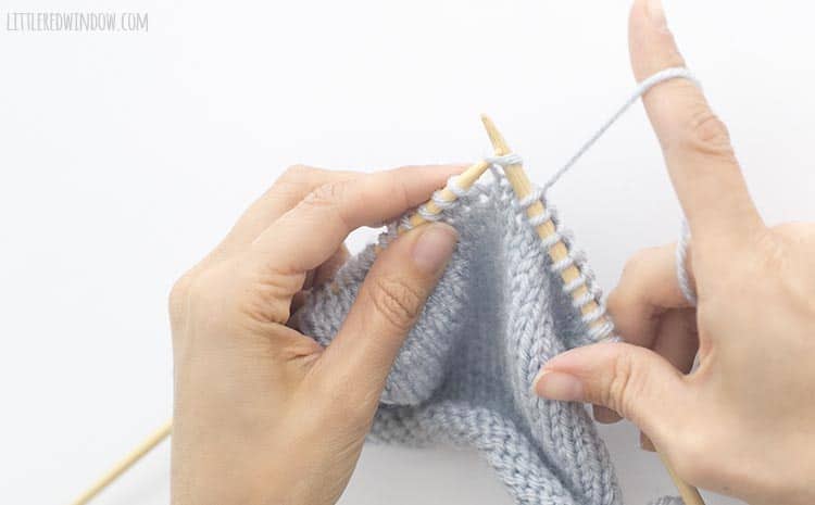 Insert the right needle through the first stitch as if to knit