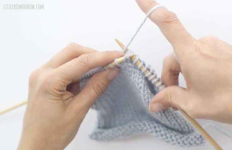 To finish an ssk stitch, wrap the yarn around the tip of the right knitting needle
