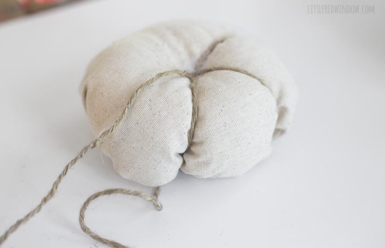 Thread a yarn needle with twine to shape your fabric pumpkins