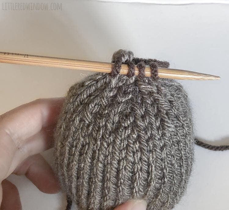 To knit the stem, transfter the remaining stitches to one knitting needle.