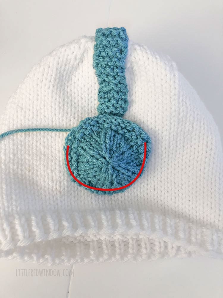 Sew the earmuffs on both sides of your snowman hat